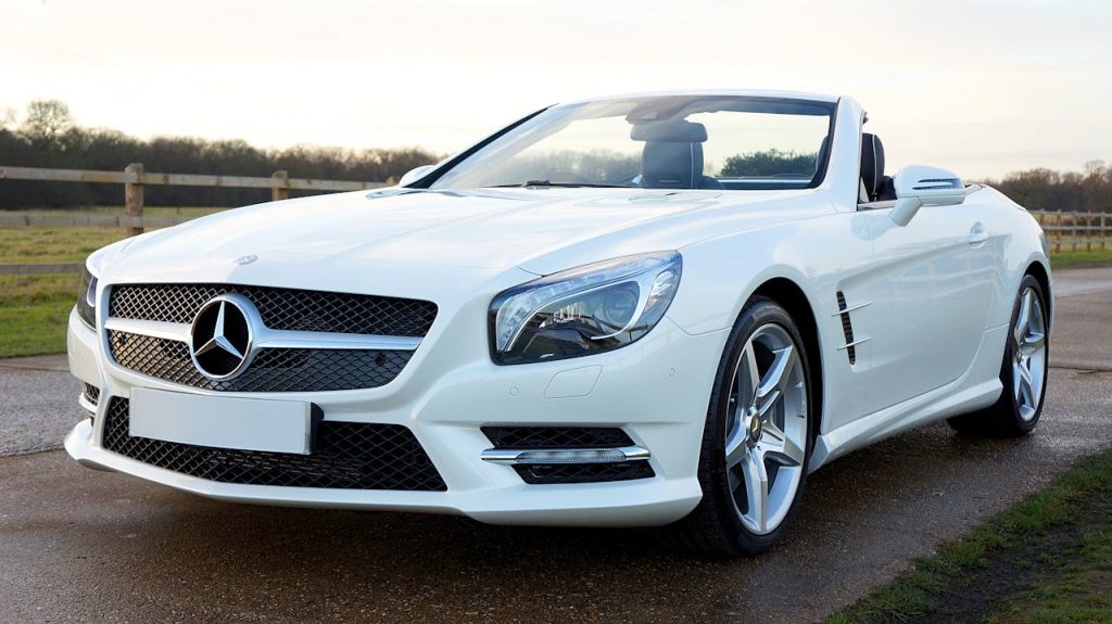 pexels-photo-12463311 Elegant white Mercedes-Benz convertible on a scenic countryside road in the United Kingdom.
