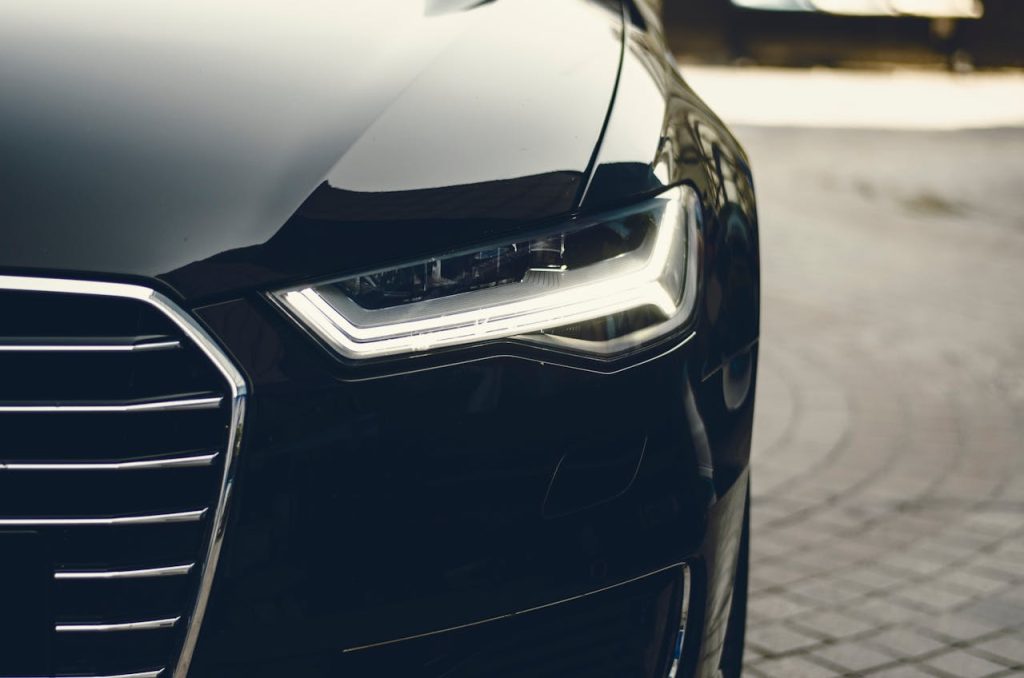 pexels-photo-305070 A sleek, modern luxury car showcasing its chrome detailing and LED headlights on a city street.